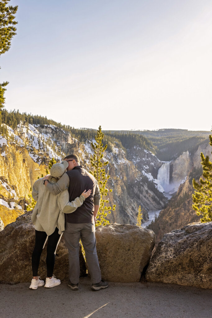 Surprise proposal portraits at sunset overlooking Lower Falls in Yellowstone.