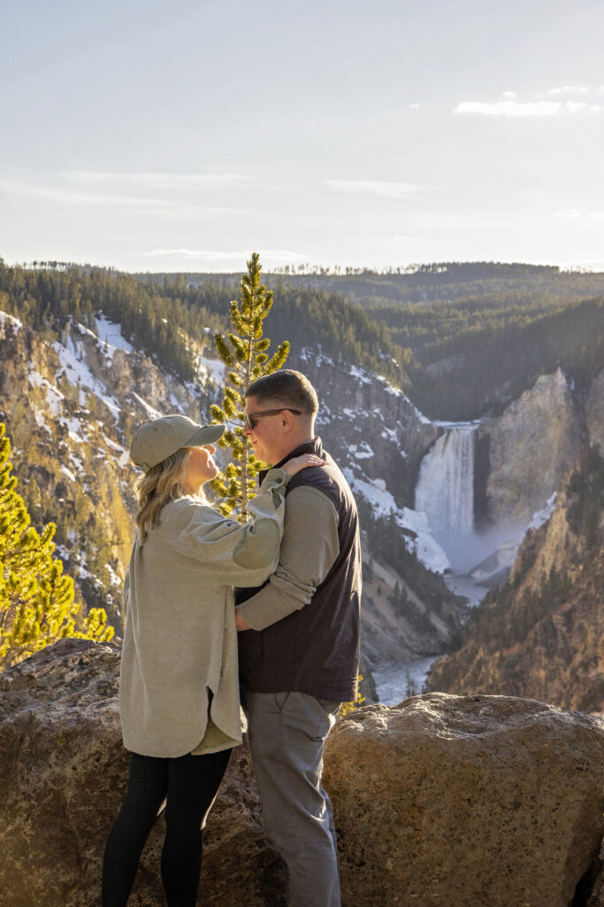 Kasey and Ashlyn smiling at each other with waterfall views behind them at Artist Point.