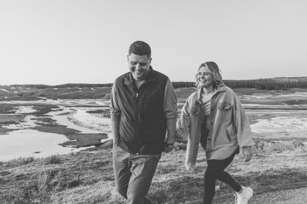 Genuine moment captured between couple during engagement session at Hayden Valley in Yellowstone.