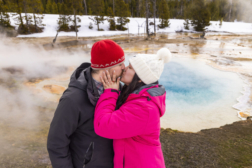 Scenic engagement photo at one of the snowcoach stops, with steaming geysers.