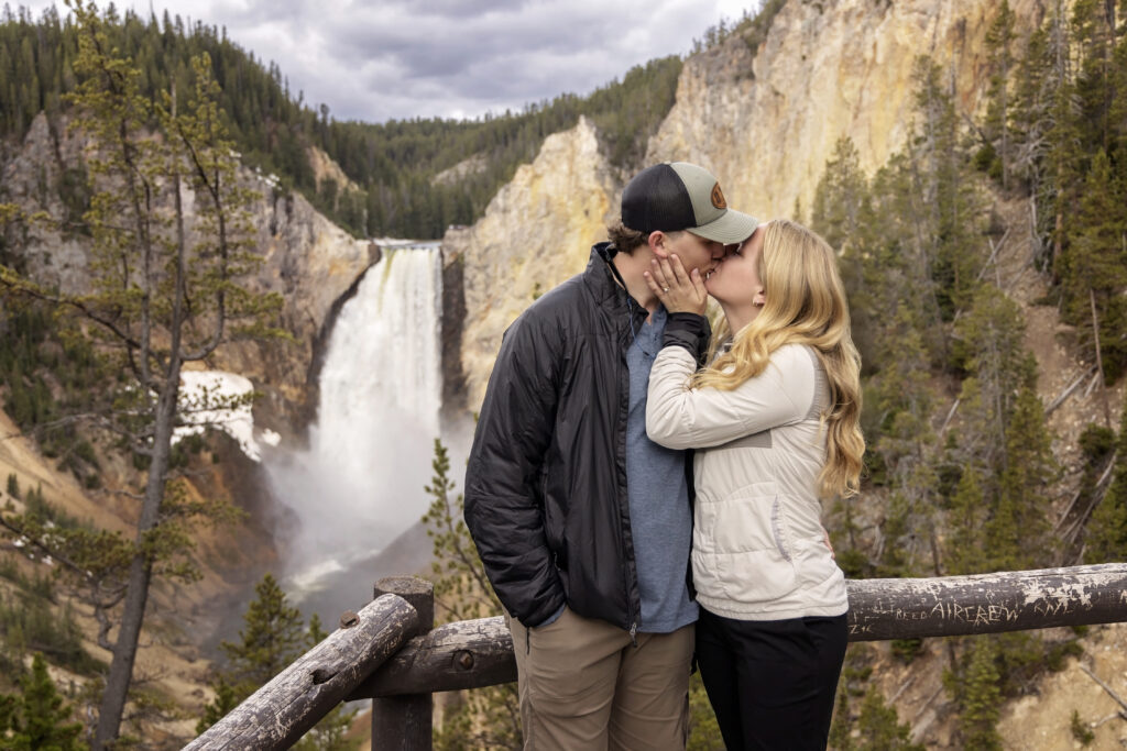 Engagement portrait of couple with Lower Yellowstone Falls in the background