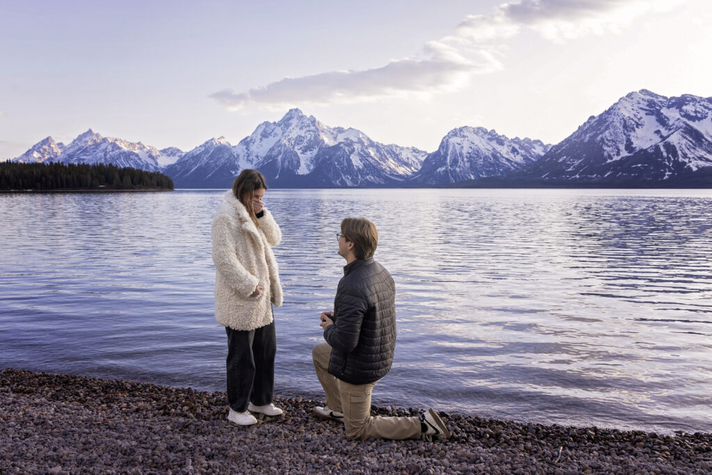 The stunning backdrop of Jackson Lake and the snow-capped Tetons created the perfect location for this romantic surprise proposal.