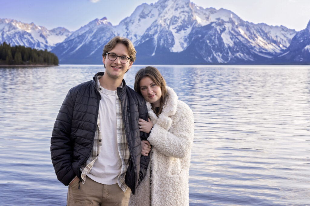 Couple standing together with the Tetons in the background