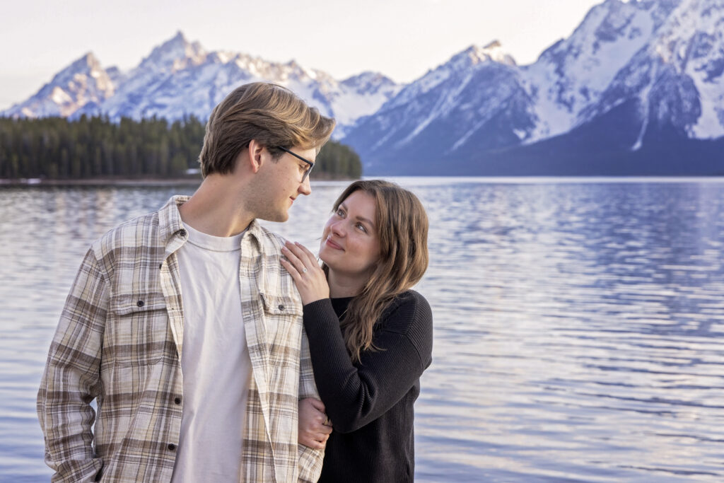 Avery and Riley smile at each other, overwhelmed with happiness and love after their Grand Teton proposal.